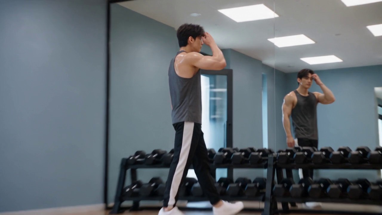 AI-generated gym scene: a man walks in and runs a hand through his hair